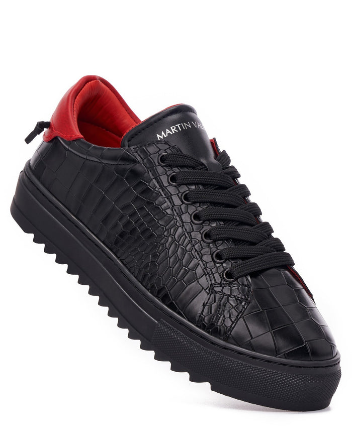 Martin Valen men's low-top black sneakers with red lining, diagonal close-up view showing crocodile-embossed texture