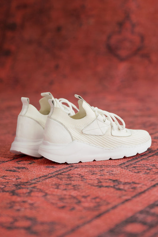 Martin Valen men's white knitted sneakers, rear three-quarter view showing ribbed knit collar and chunky sole on red background