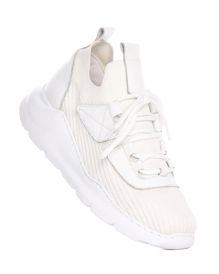Martin Valen men's white knitted sneakers, three-quarter view showing laces, ribbed upper and chunky sole