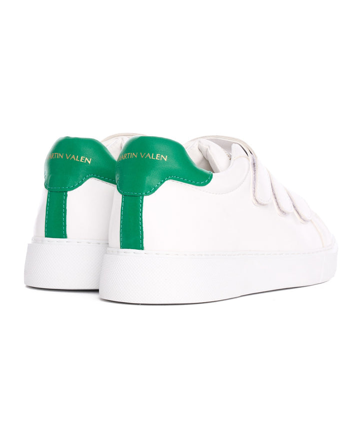 Martin Valen men's white sneakers, rear three-quarter view showing green heel tab with gold logo and Velcro straps.