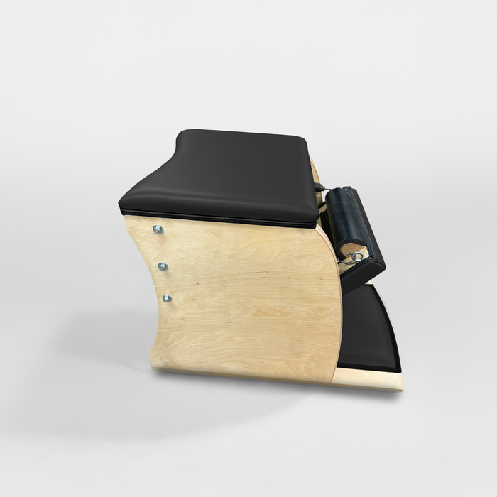 Gratz Wunda Chair with black upholstery and light birch wood frame, side view.