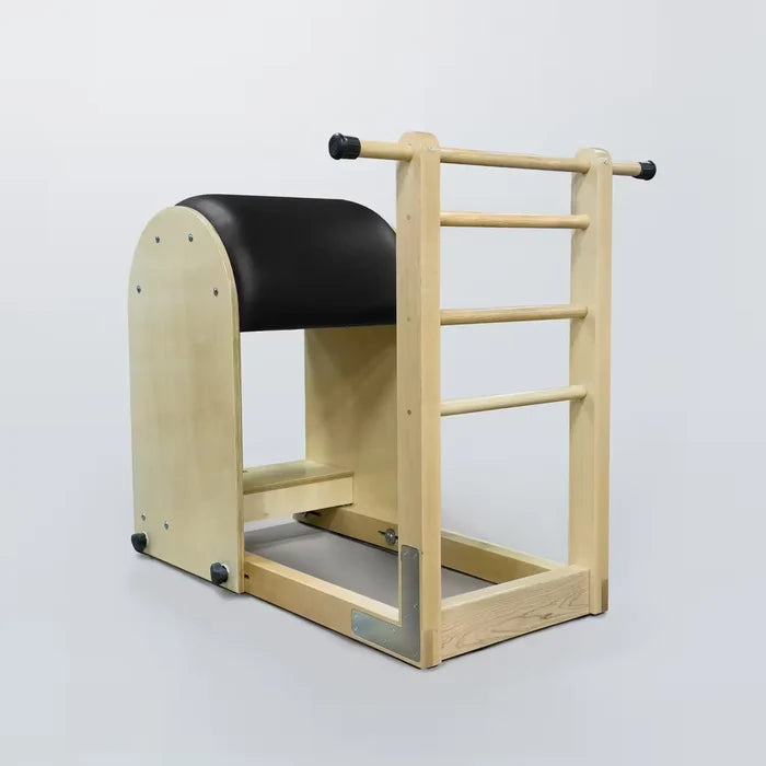 Pilates ladder barrel in natural maple wood with black padded curved top and horizontal rungs for spine stretching and core exercises.
