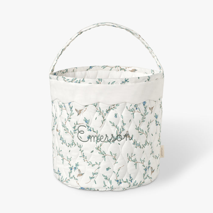Quilted basket with Secret Garden pattern on a white background.