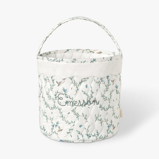 Quilted basket with Secret Garden pattern on a white background.