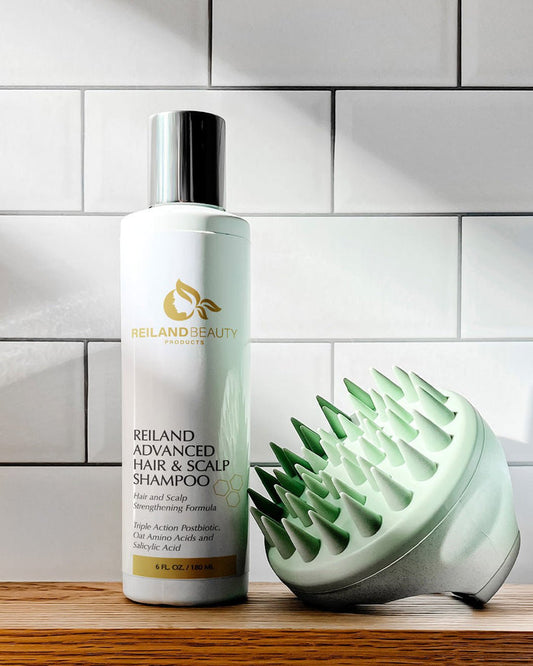 Reiland Advanced Hair & Scalp Strengthening Shampoo with Free Scalp Massager – 6 fl. oz. bottle. Triple Action Postbiotic formula with Oat Amino Acids and Salicylic Acid. Promotes healthy hair growth, clears buildup, and soothes dry scalp.
