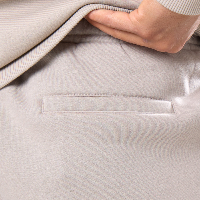 Close up of pocket detailing on back of loose tracksuit bottoms
