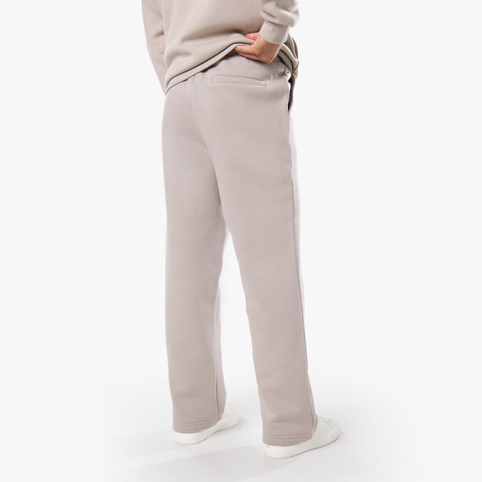 Rear view of tracksuit bottoms in stone