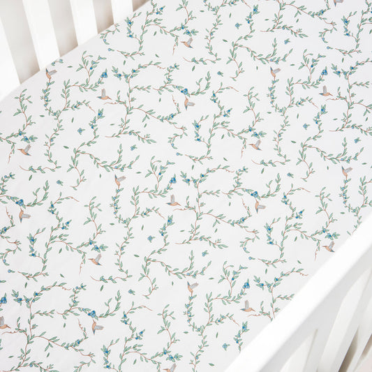 Crib Sheet in the "Secret Garden" print in the color ivory featured in a crib