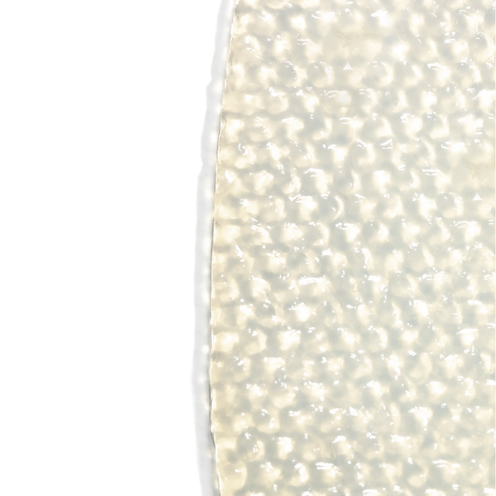 Close-up of a translucent, textured sheet mask material highlighting its soft, cushion-like cellular structure for the SkinTensity Advanced BioCellular Sheet Masque | Skin Fitness Therapy skincare product.