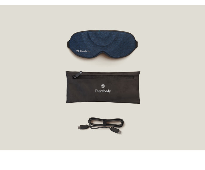 Therabody Sleepmask | Therabody shown with a navy blue sleep mask, black zippered carrying pouch, and a charging cable, designed for enhancing wellness and recovery.