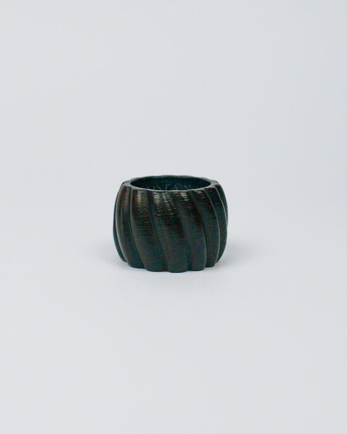 Dark wooden ribbed napkin ring on a white background