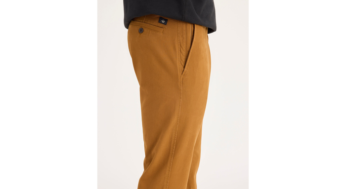 Side view of model wearing Dark Ginger Ultimate Chinos, Athletic Fit.