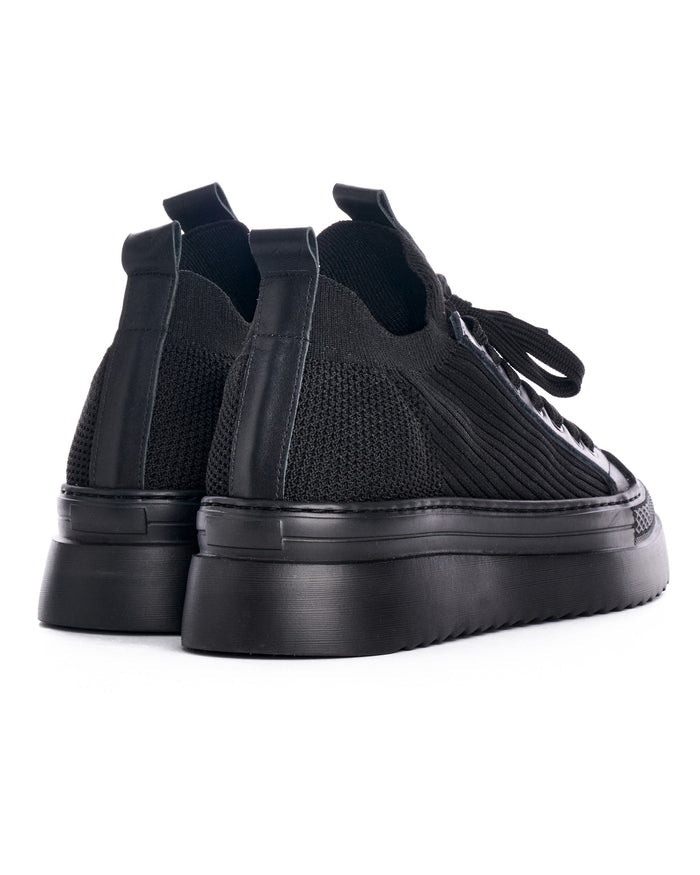 Martin Valen Valento black knitwear sneakers rear three-quarter view highlighting knit heel texture, pull tabs and raised platform sole